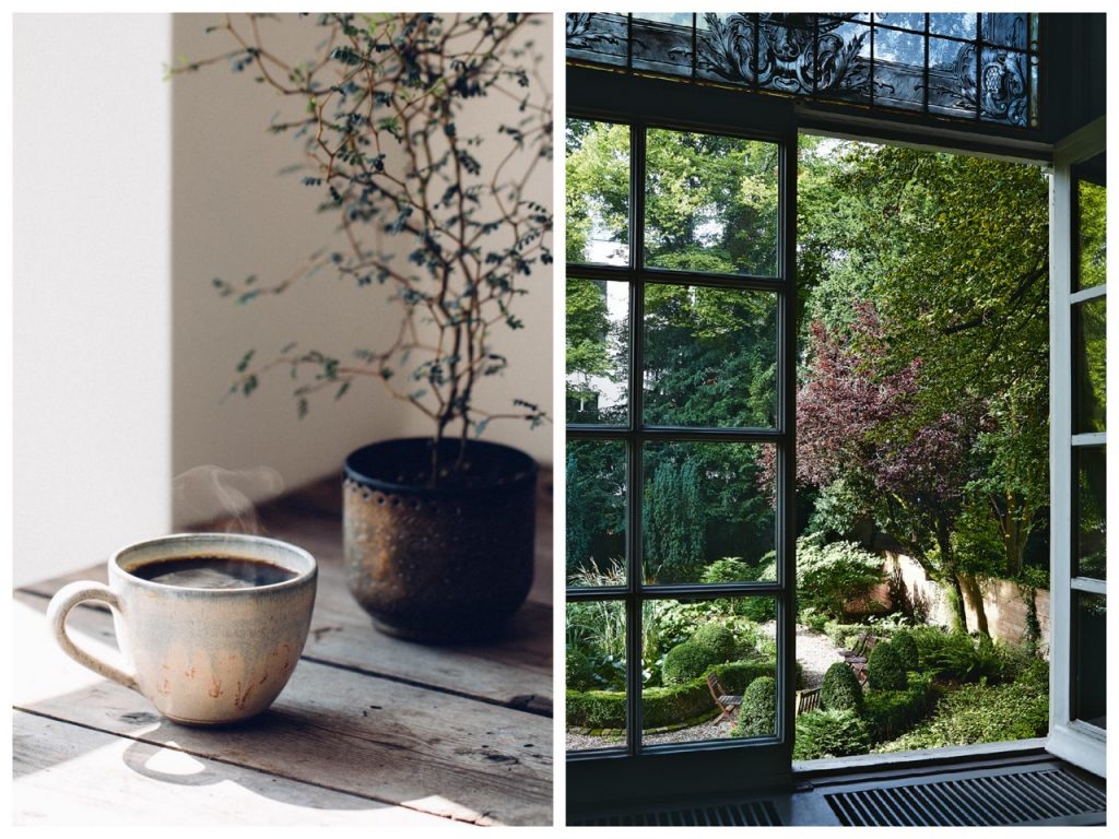 Steaming black coffee next to open door looking out to gardens