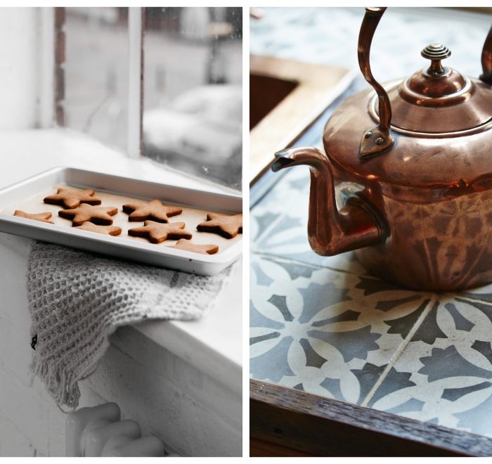 Copper kettle sits on tile worktop next to baked ginger bread stars