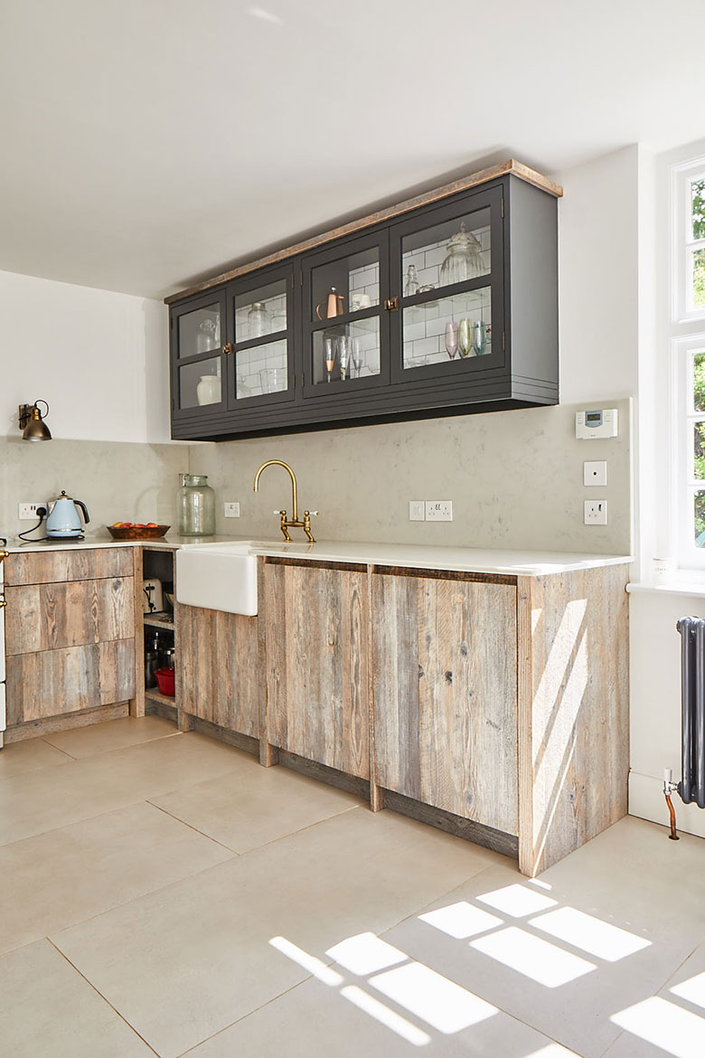 Reclaimed pine kitchen units and cream stone tiled floor