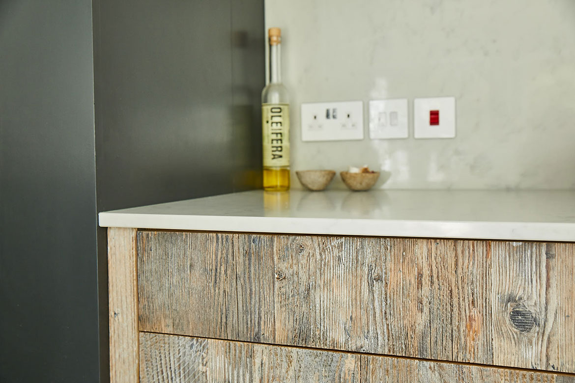 Engineered drawer fronts made from reclaimed rustic pine with white quartz worktop