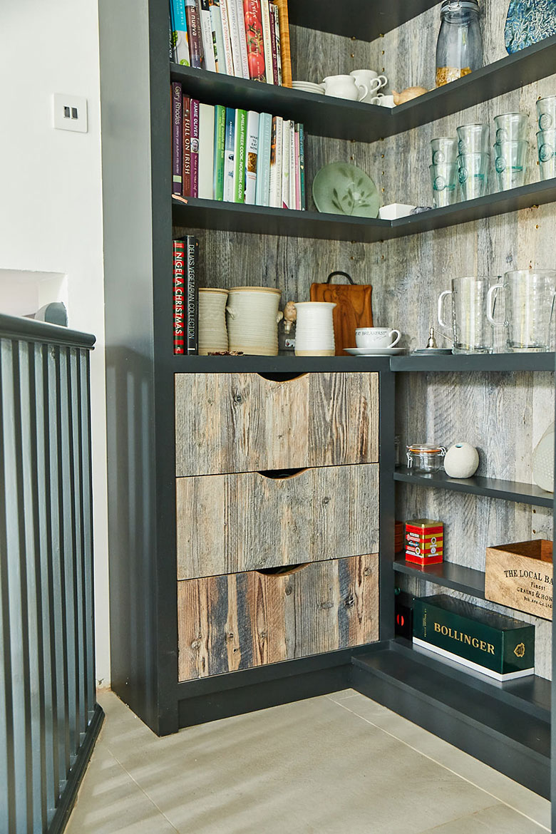Open shelving unit painted in lamp black by Little Greene with reclaimed pine backboards and drawers