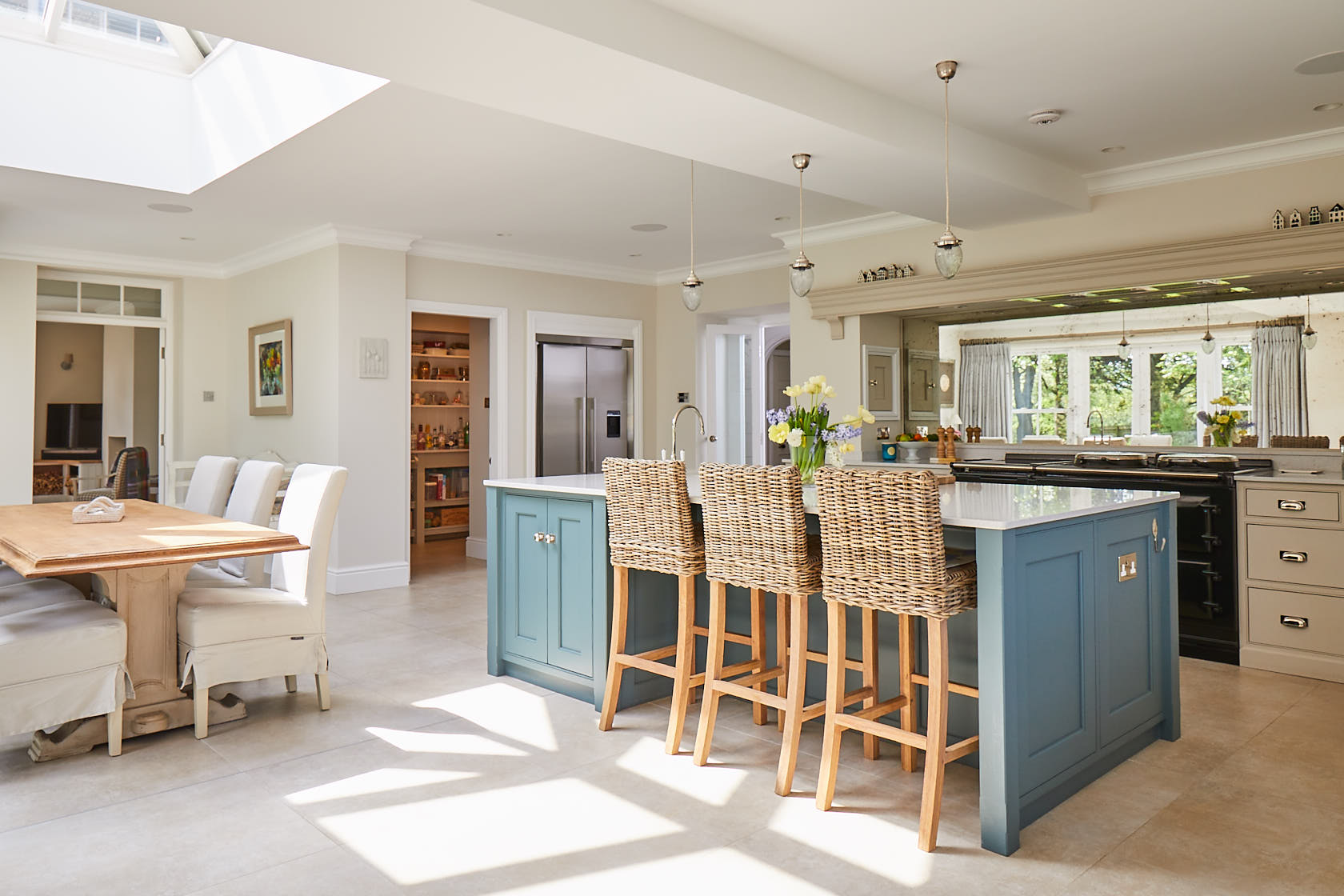 Open plan kitchen with bespoke kitchen island incorporating breakfast bar stools