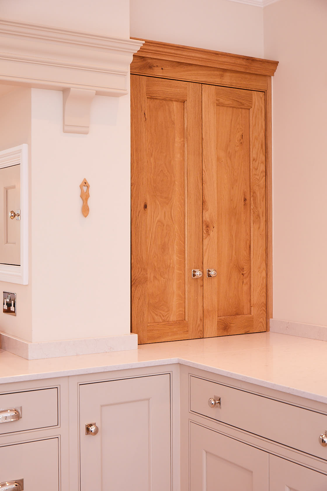 Solid oak bi fold wall unit fitted in between chimney and wall