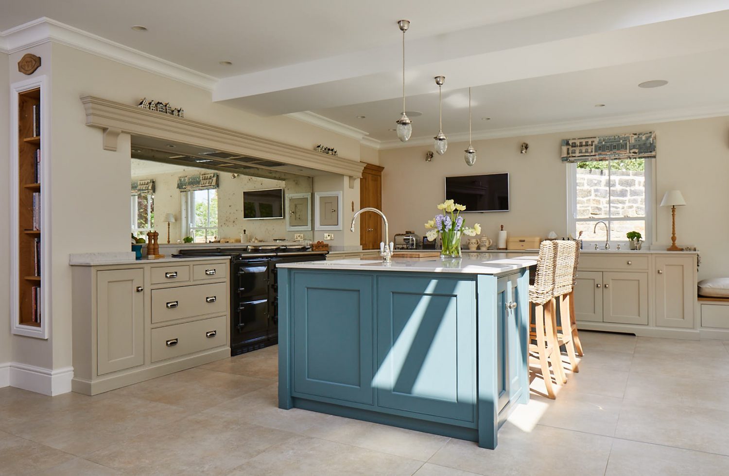 Shadow casts down on green kitchen island with integrated breakfast bar