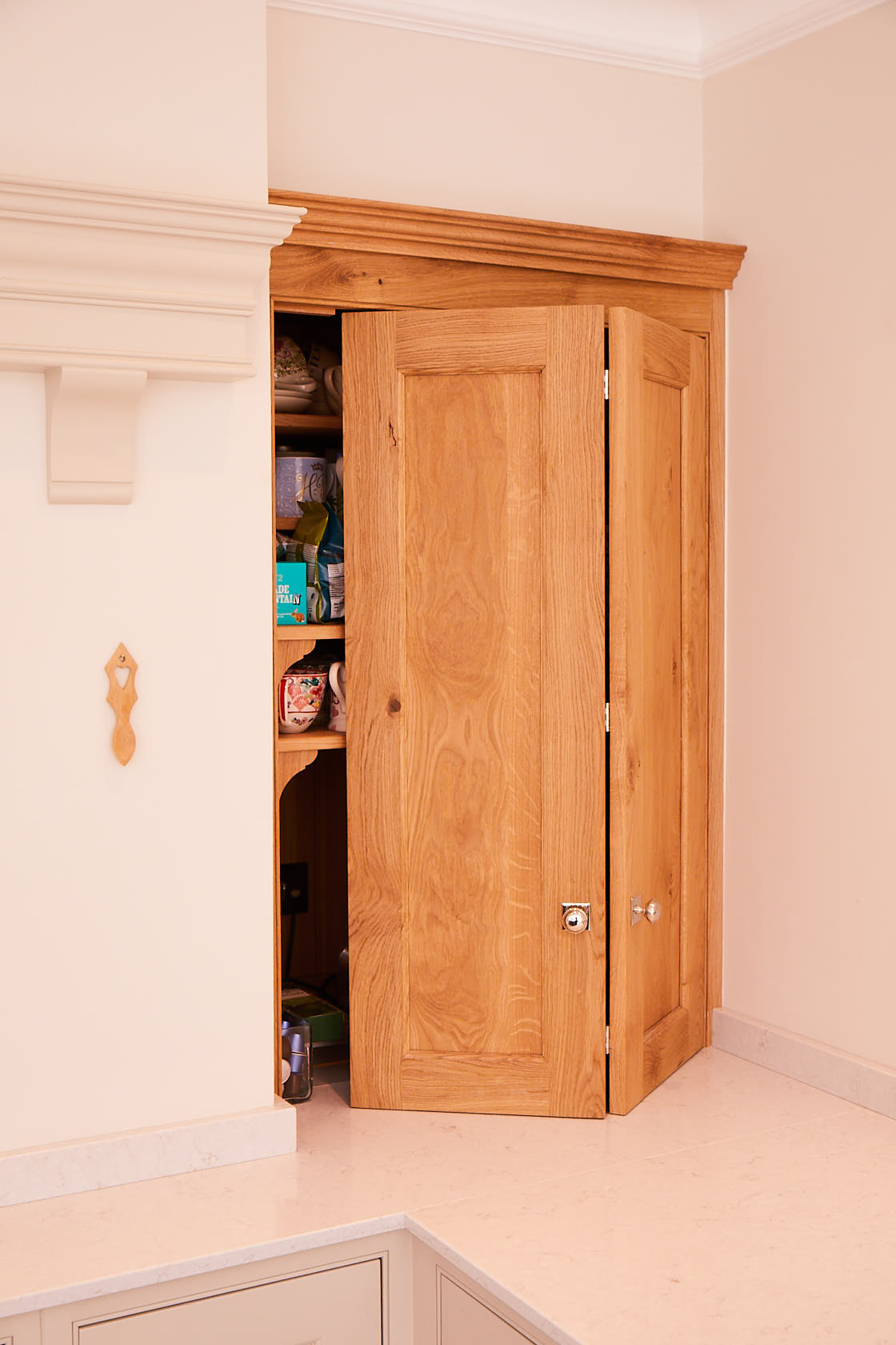 Solid oak bi fold wall unit open fitted in between chimney and wall