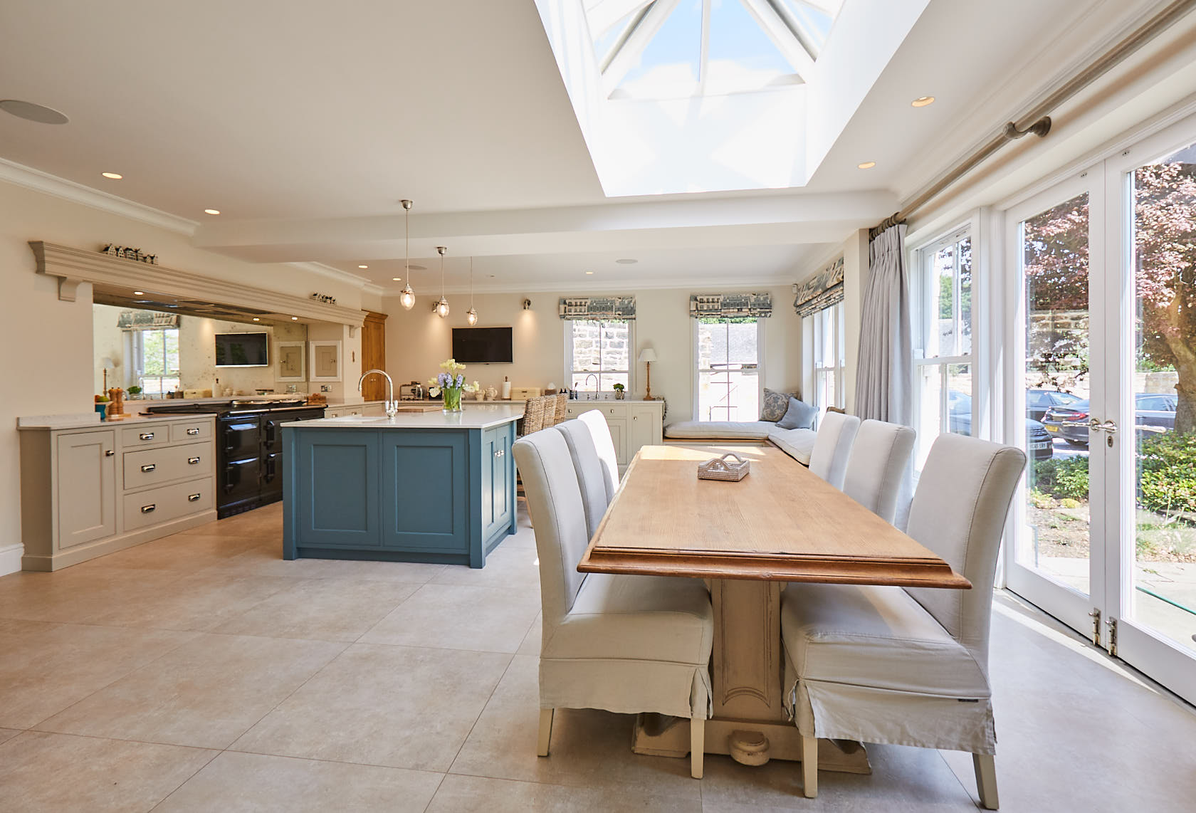 Upholstered chairs around table in open plan kitchen