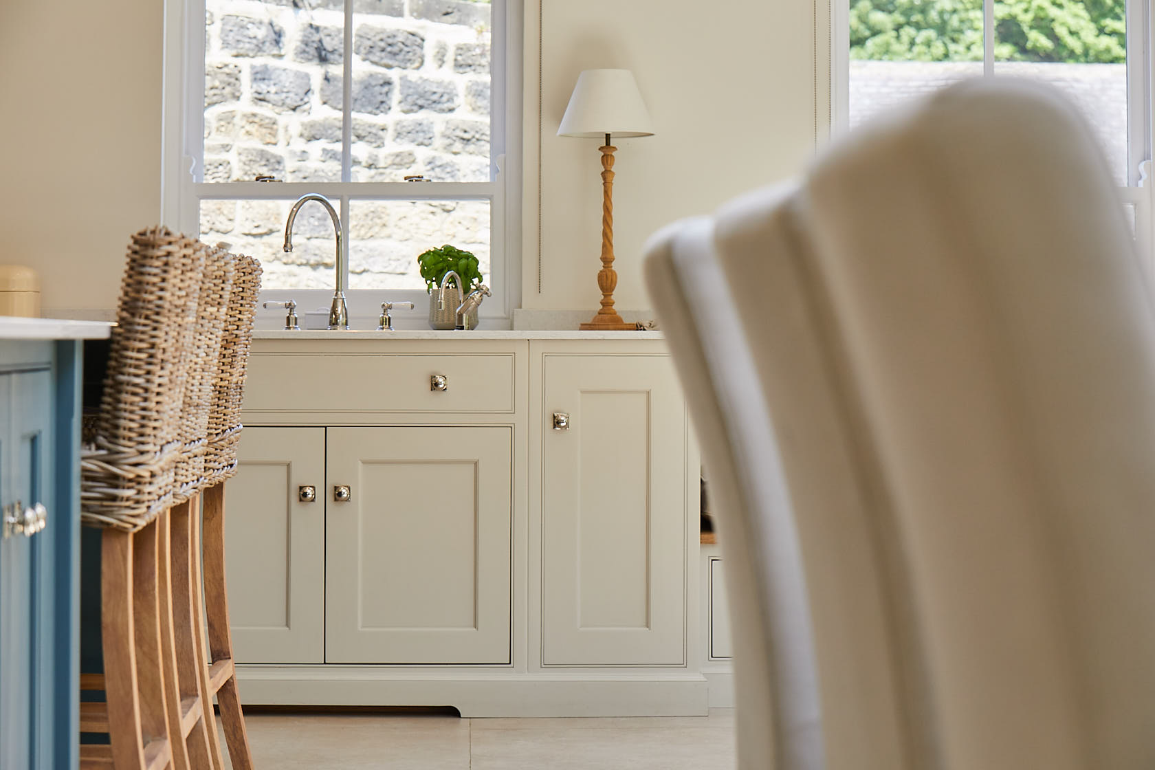 Cream painted sink cabinet with traditional plinth cut out for toes