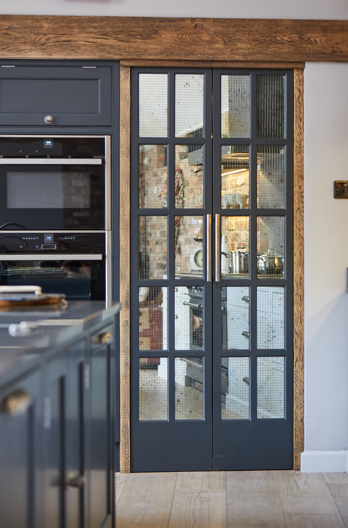 Pair of bespoke pantry doors with Rough Old Glass mirror and rustic wood surround