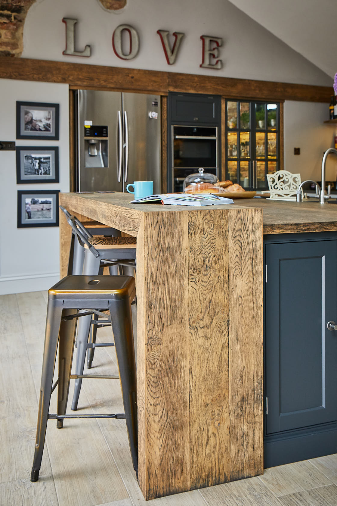 Wrap around chunky oak breakfast bar with industrial metal bar stool