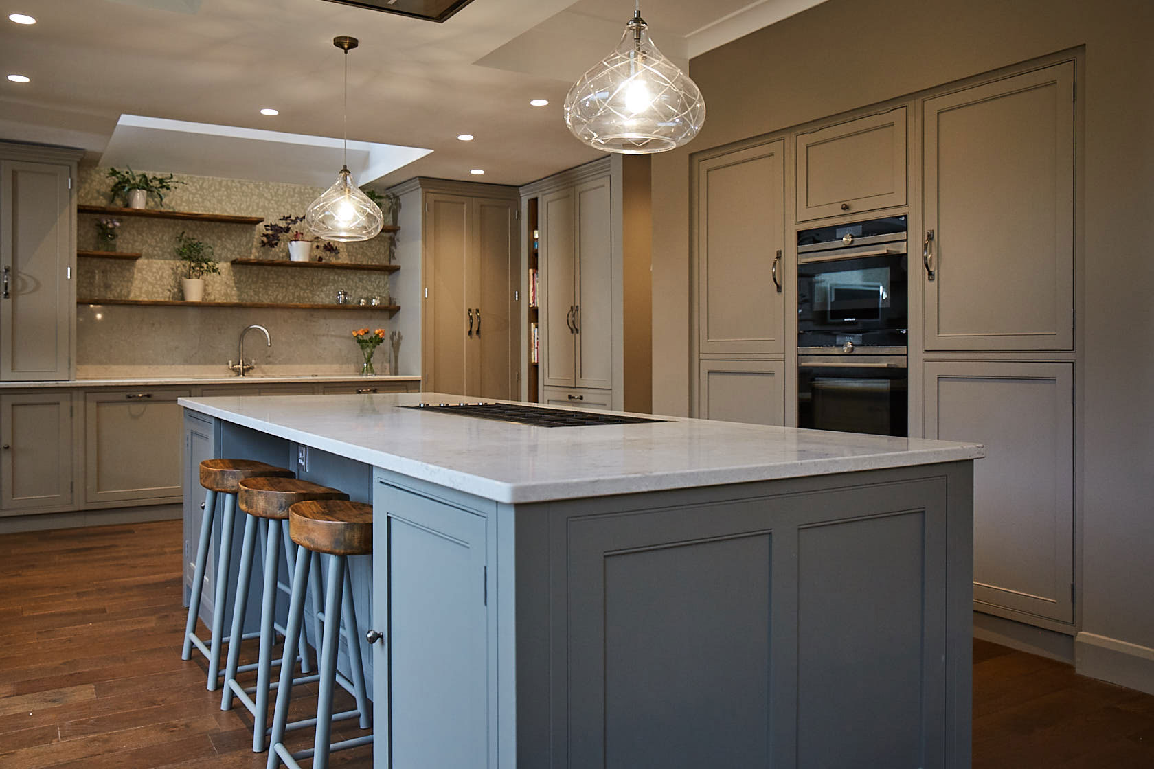 Crystal pendant light over kitchen island with white worktops