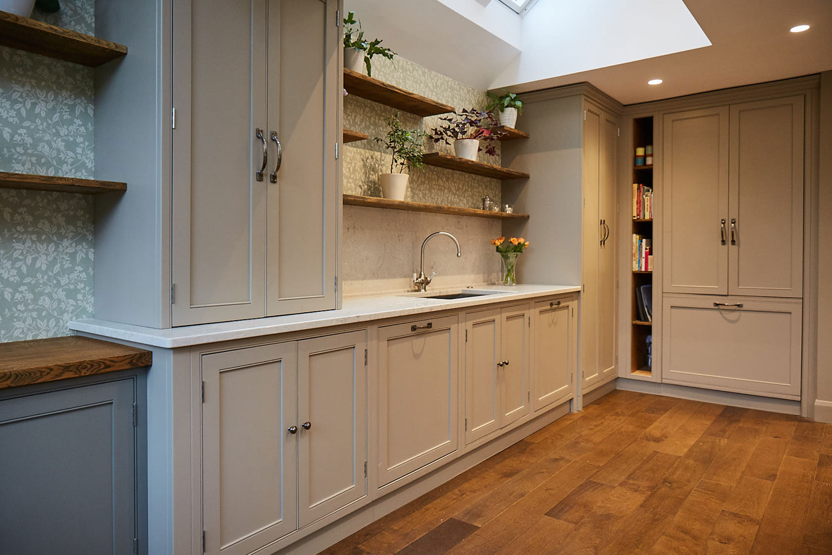 Sink run with asymmetrical oak open shelves above