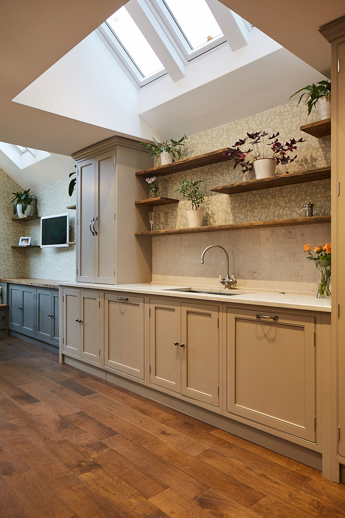 Mixture of painted cabinets and floating oak shelves