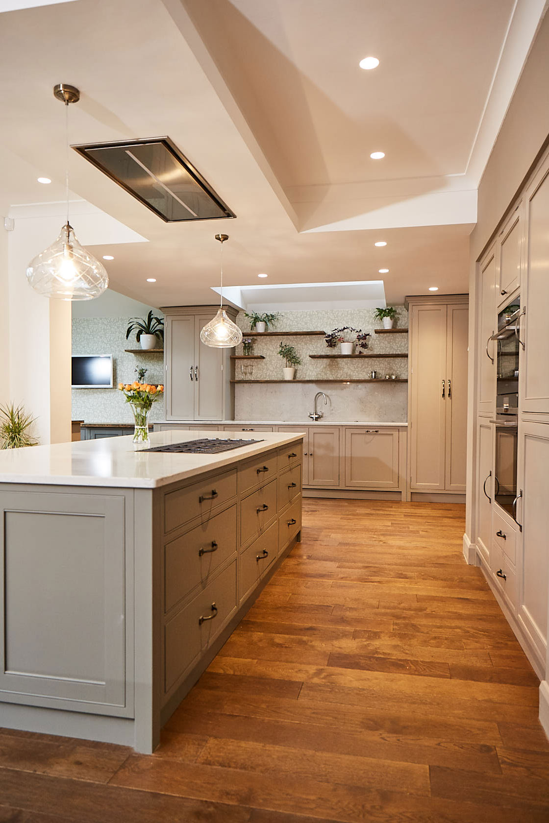 Pan drawers make up kitchen island on oak engineered floor