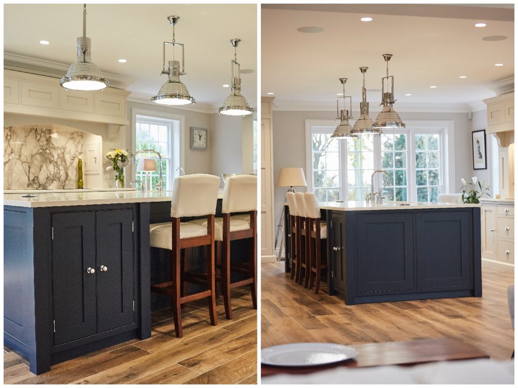 Dark blue kitchen island with white leather bar stools