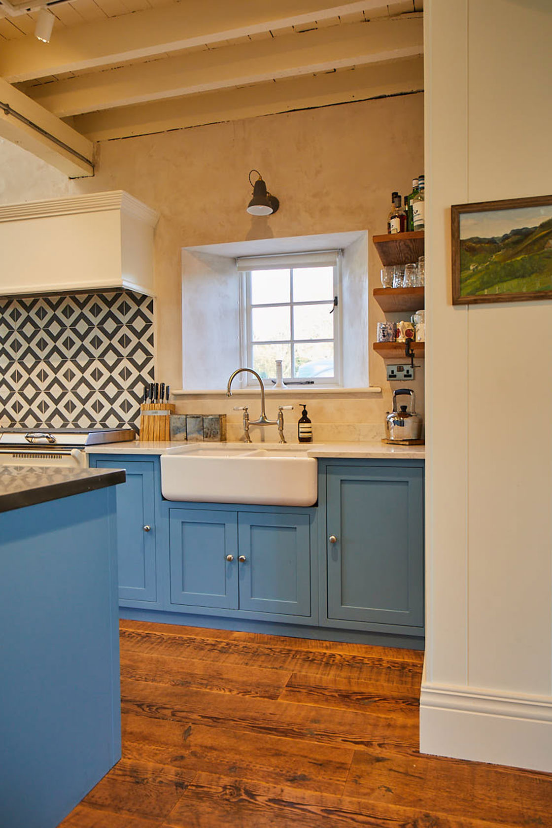 Sink run with stainless steel mixer tap traditional shaker cabinets and ceramic belfast double sink