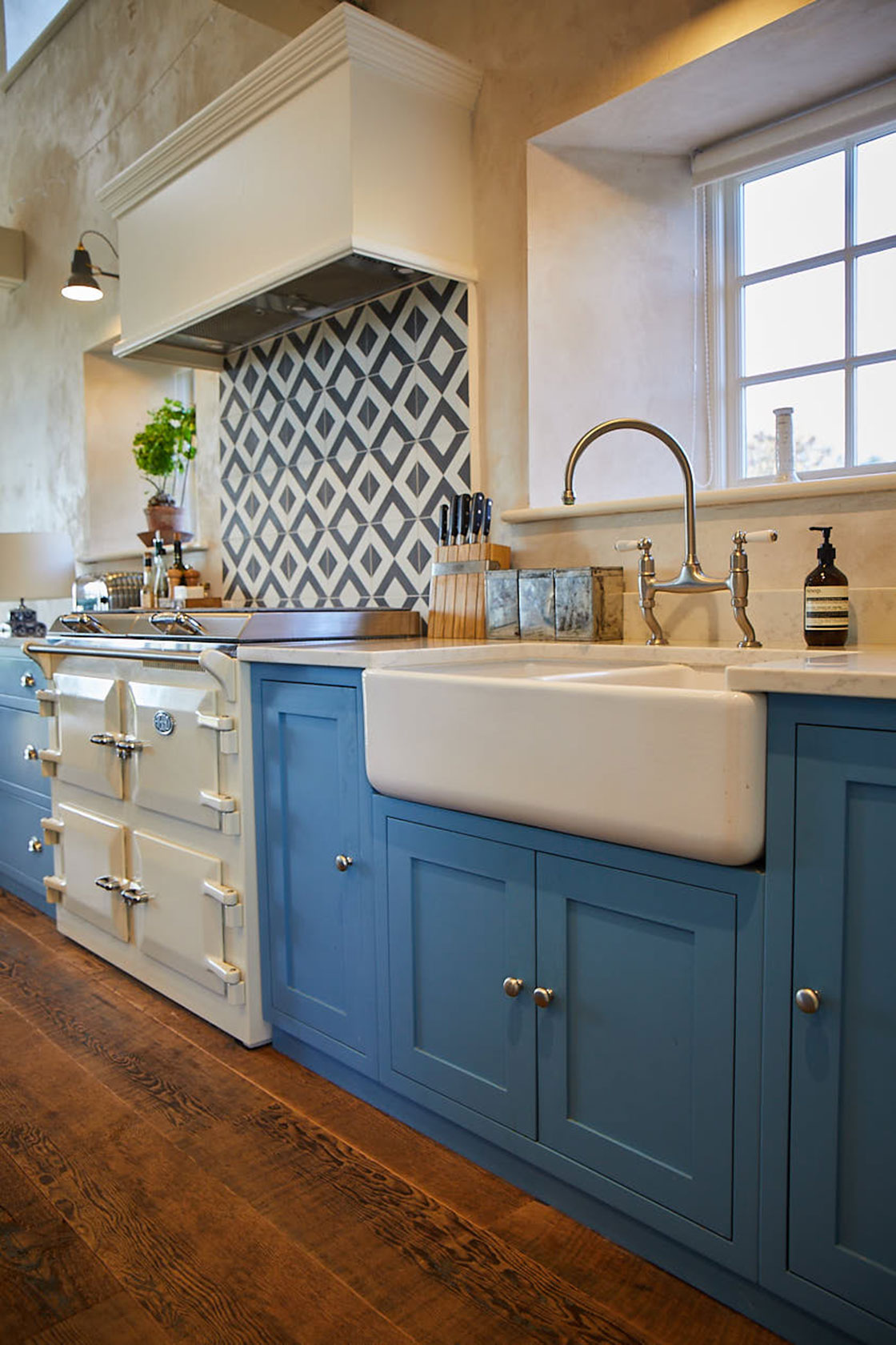 Bespoke light blue shaker kitchen cabinets with reclaimed pine wood floor