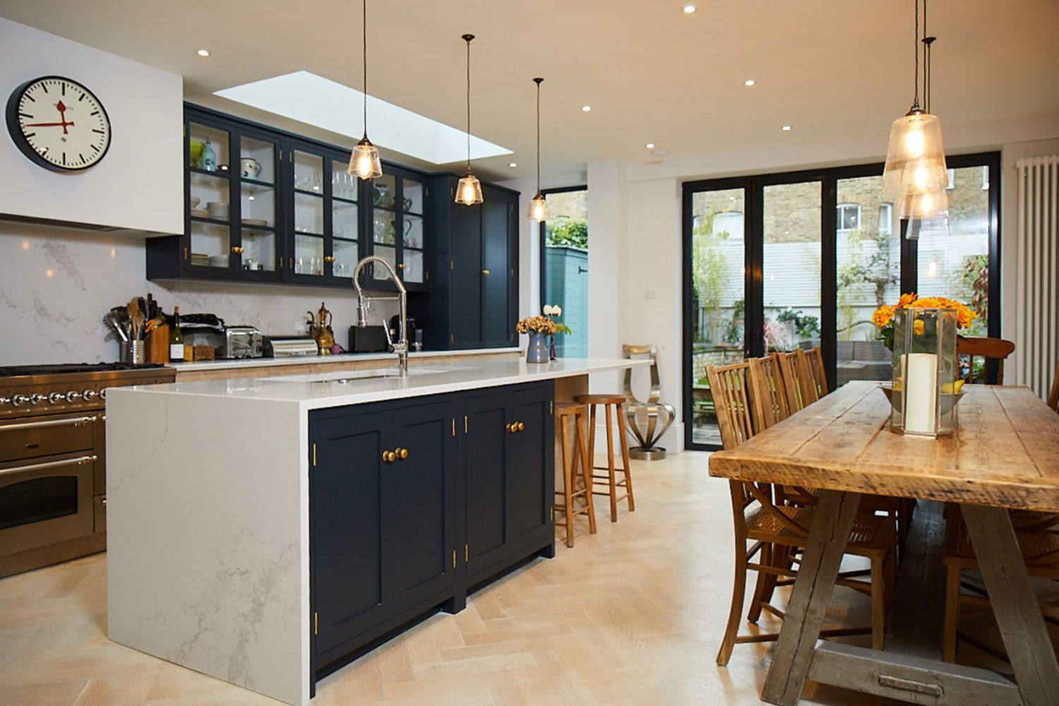 Dark blue kitchen island with waterfall Caesarstone worktopw