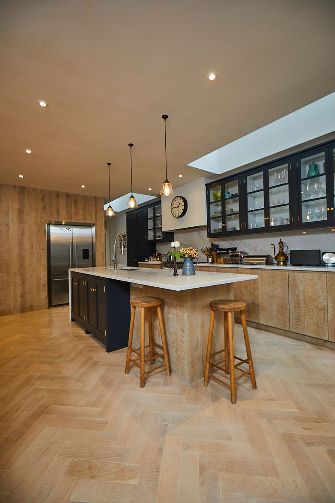 Solid oak barstools sit under kitchen island