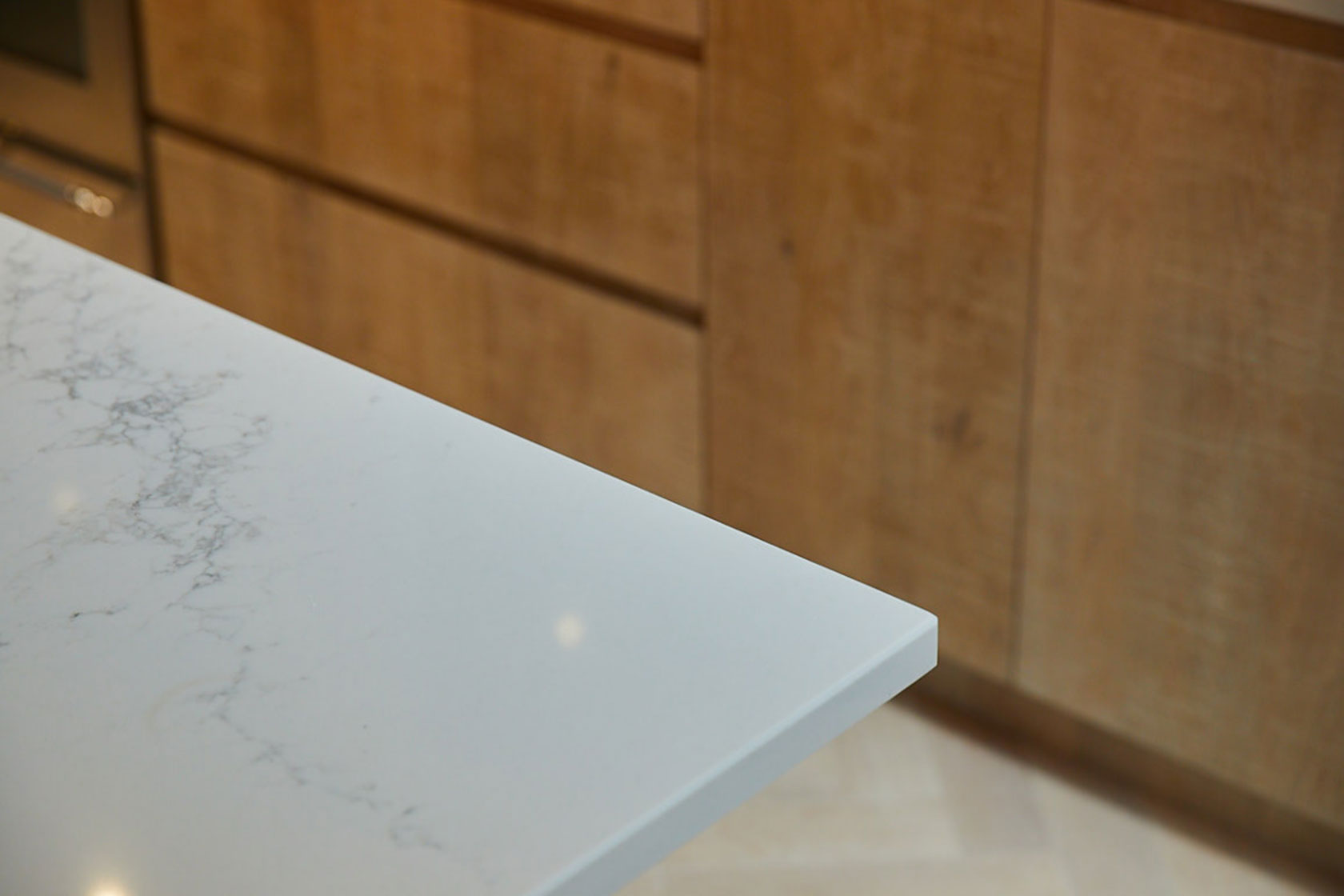 White Caesarstone worktop with limed washed oak kitchen door