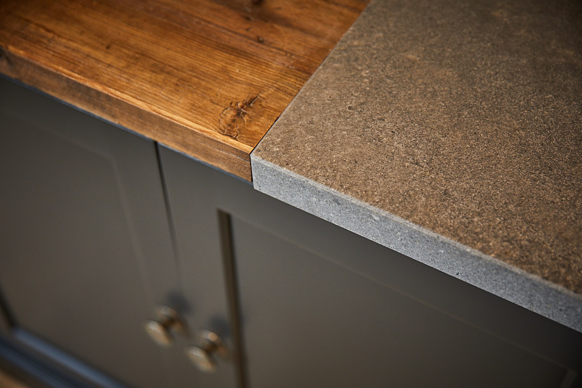 Reclaimed pine and grey Caesarstone worktops sit on kitchen cabinets