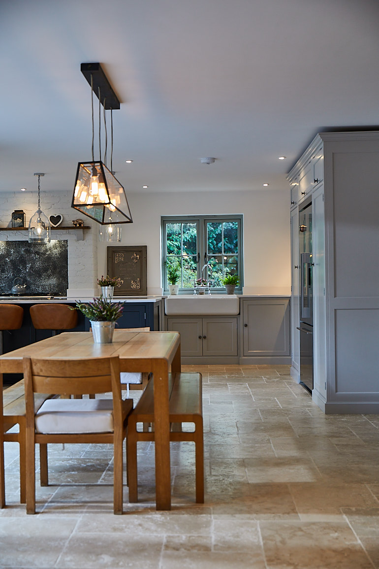 Contemporary oak dining table and bench in open plan kitchen