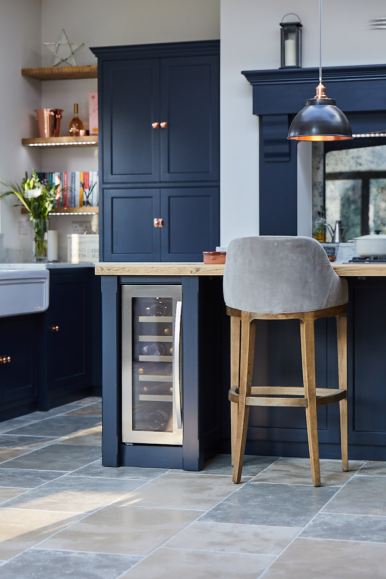 Wine cooler in kitchen island with two painted chunky posts in dark blue