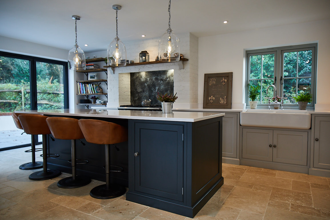 Light brown leather bar stools under painted island