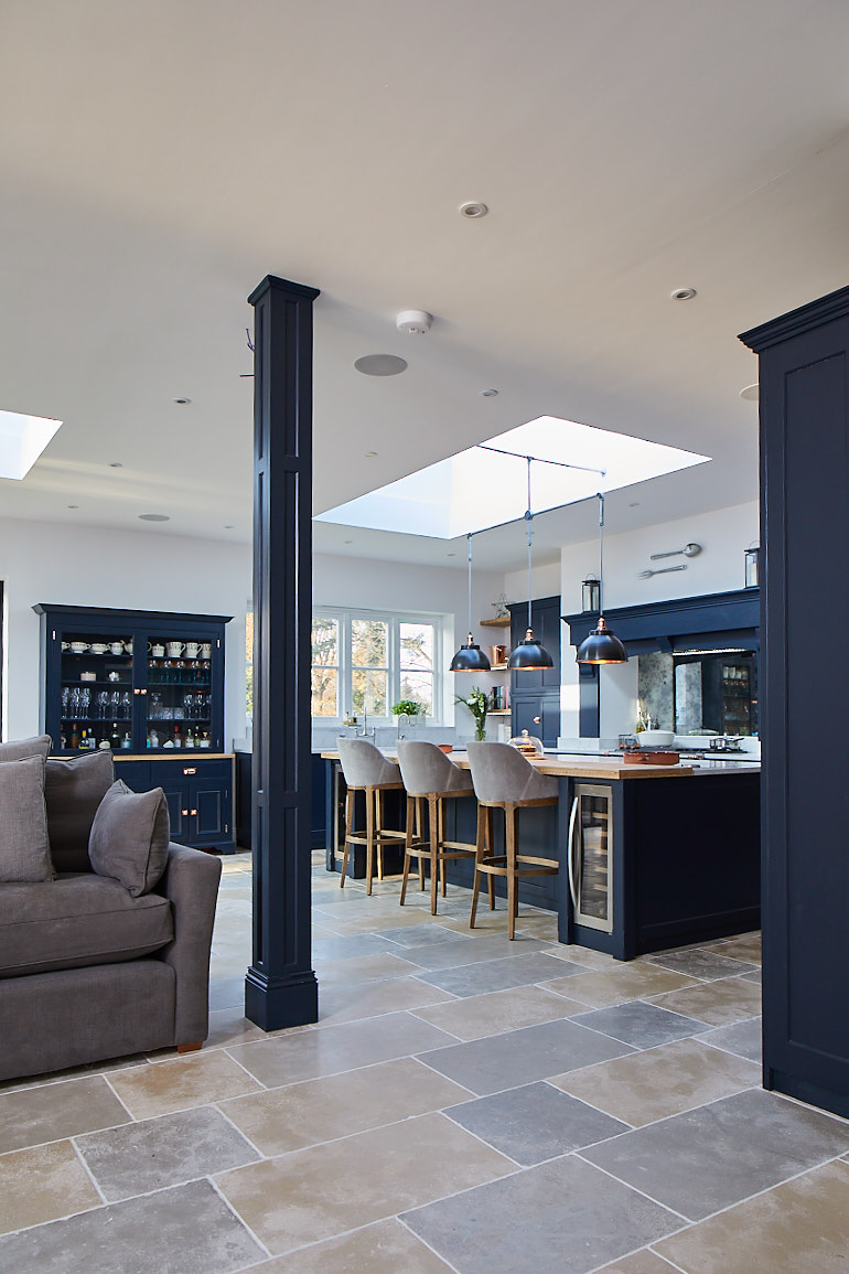 RSJ pillar cladded in dark blue painted panel to match bespoke kitchen