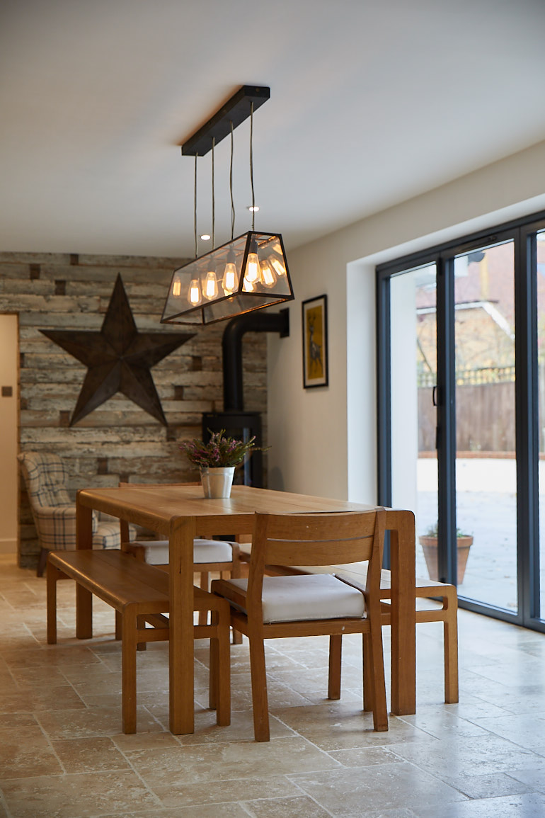 Oak dining table and chairs with pendant light bulbs above