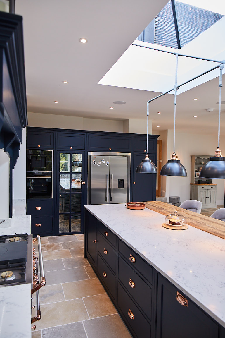 Pan drawers and integrated bin in kitchen island painted in dark blue by Little Greene Paint Company