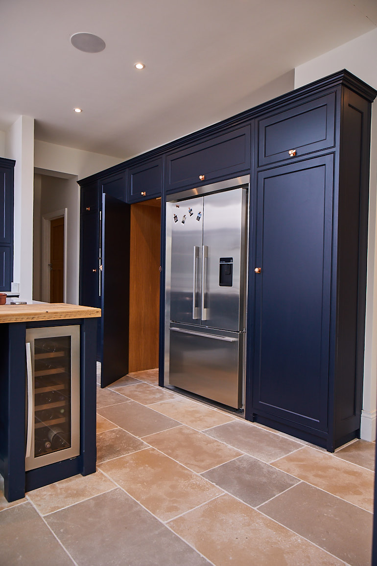 Secret pantry door to look like kitchen cabinet painted in dark blue