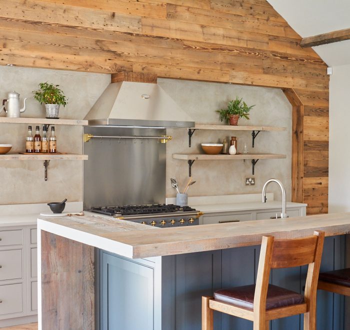Oak barstools under reclaimed engineered breakfast bar on bespoke kitchen island