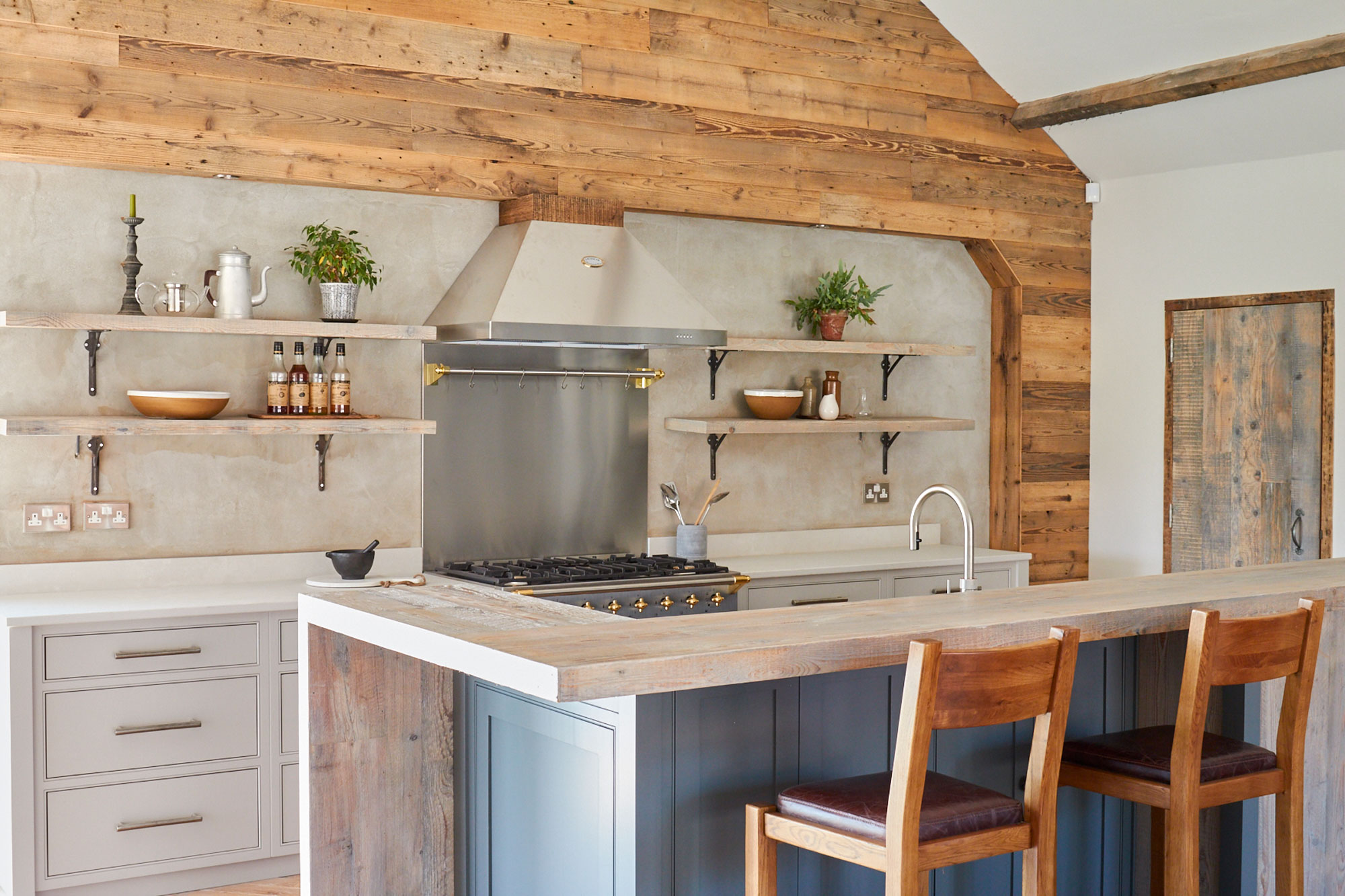 Oak barstools under reclaimed engineered breakfast bar on bespoke kitchen island