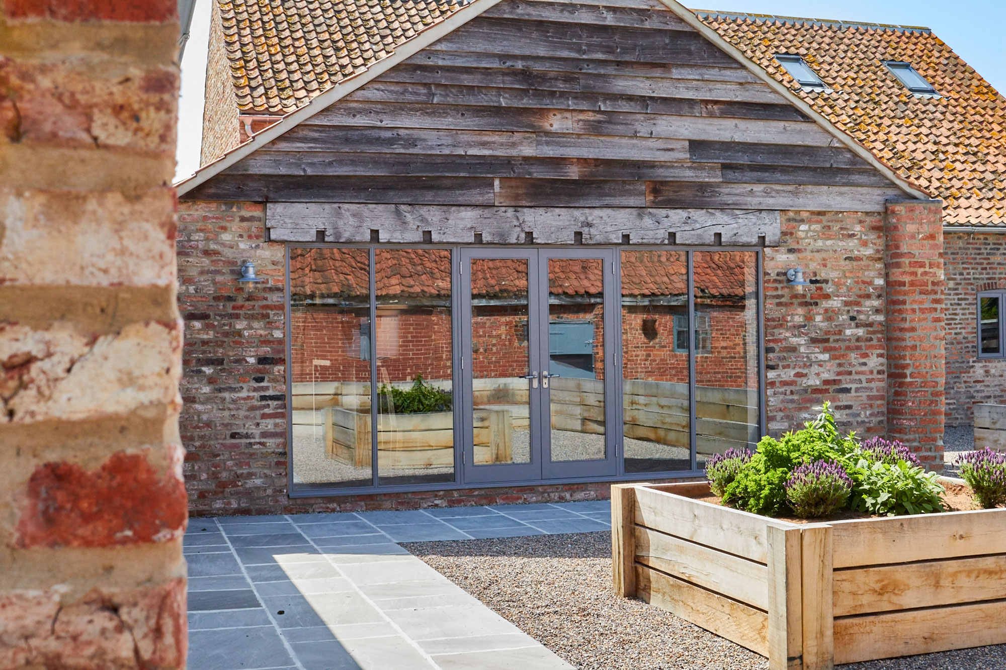 External wood cladding above glass patio doors