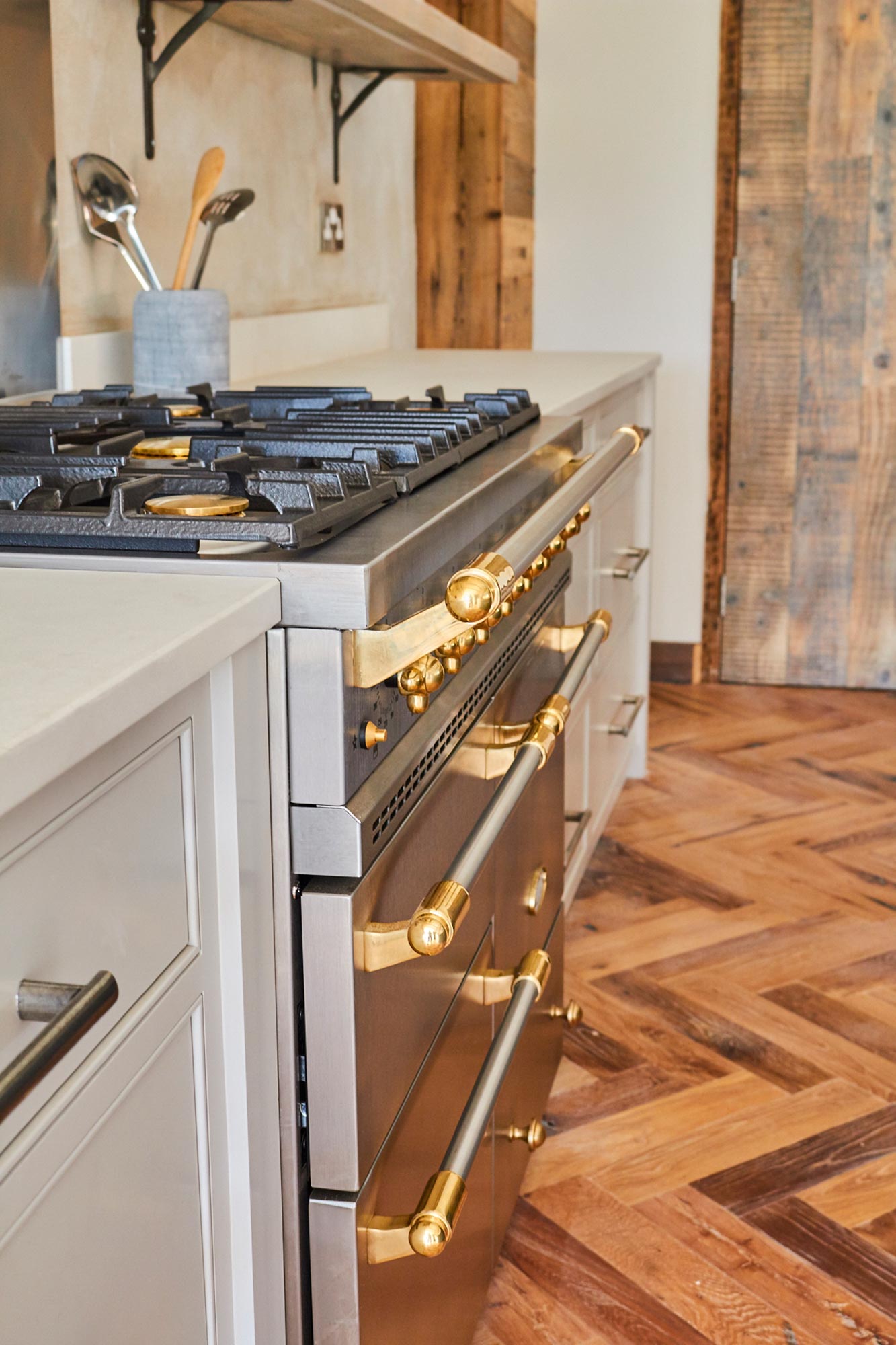 Stainless steel range cooker sits on herringbone oak floor