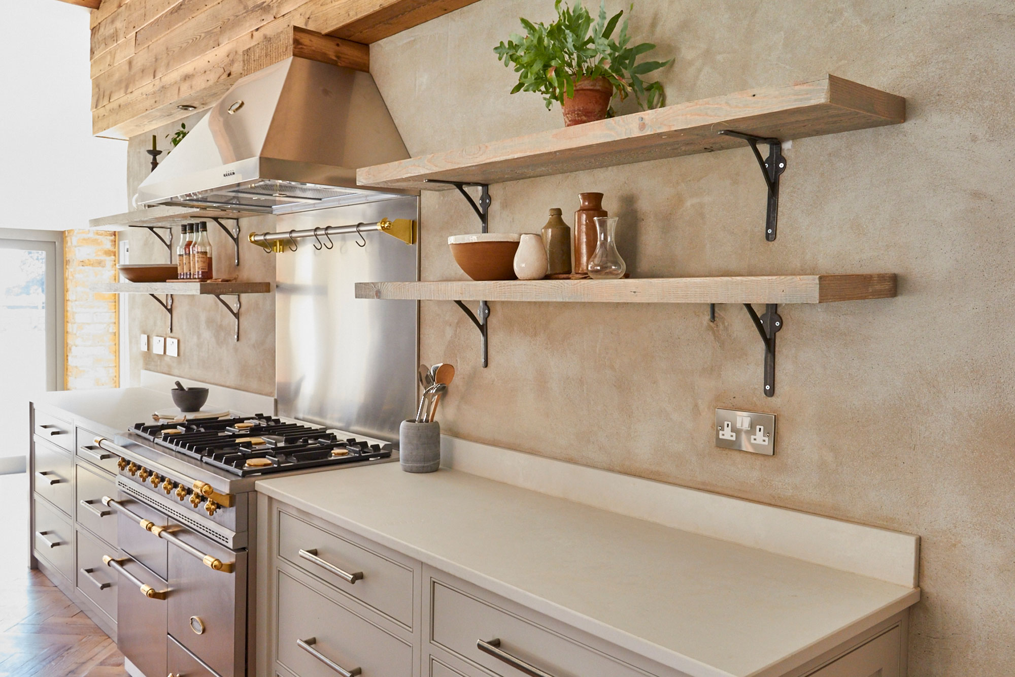 Rustic open shelves above Caesarstone white worktop and bespoke kitchen pan drawers