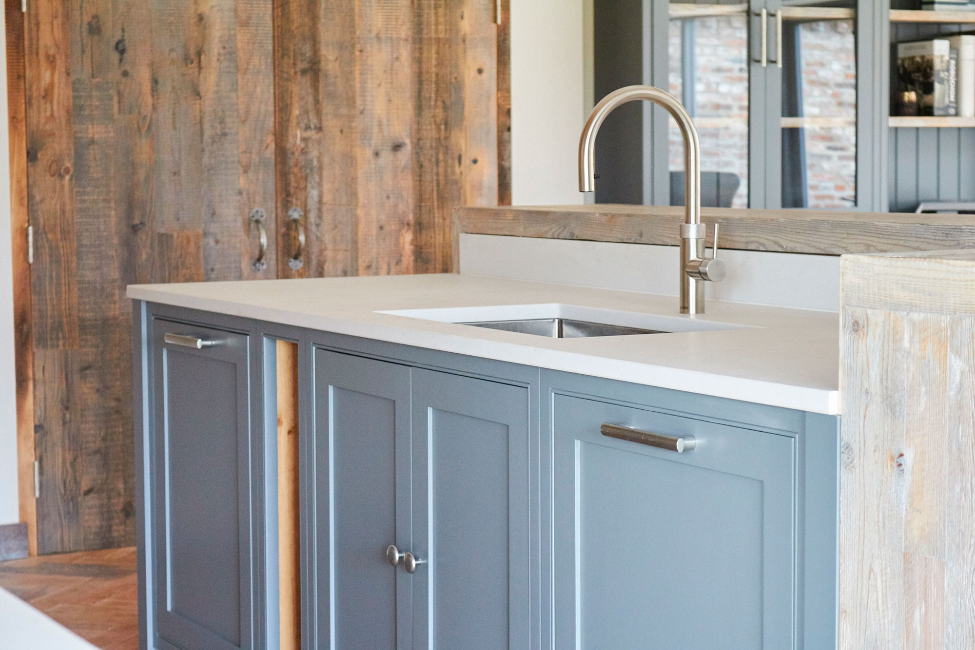 Painted kitchen cabinets with inset stainless steel sink and tap