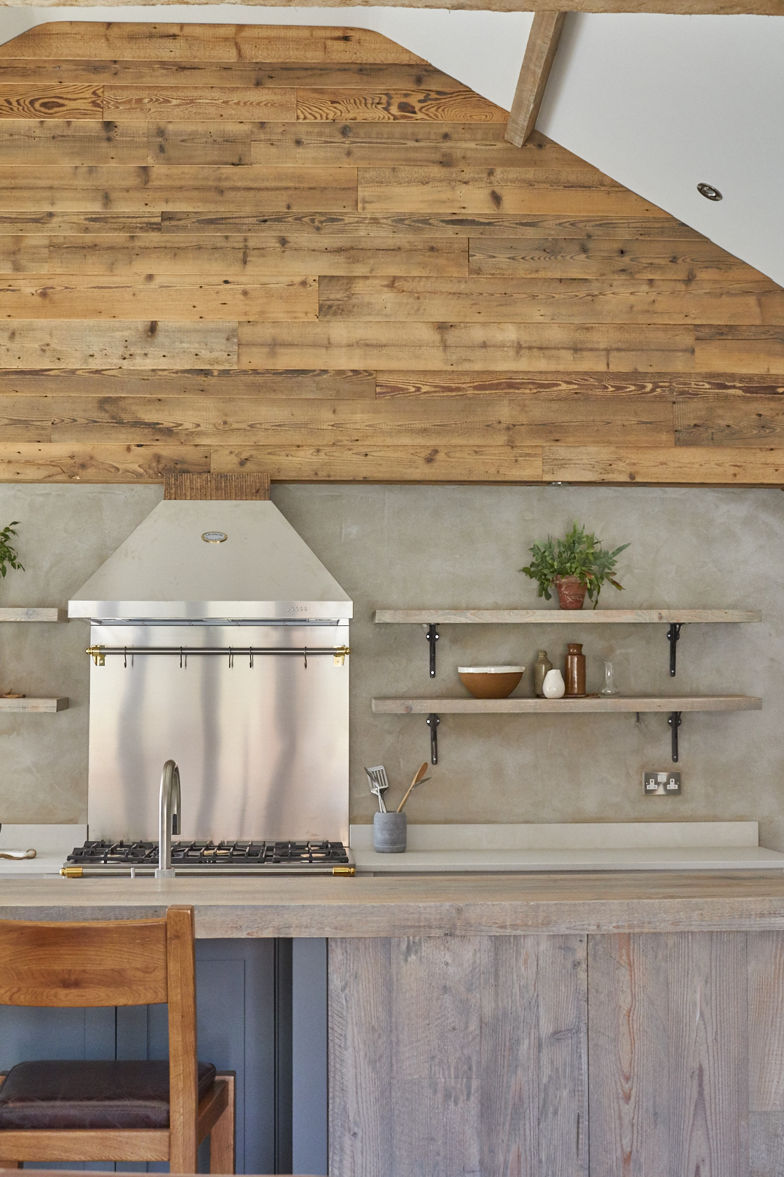 Reclaimed pine cladding above open plan bespoke kitchen