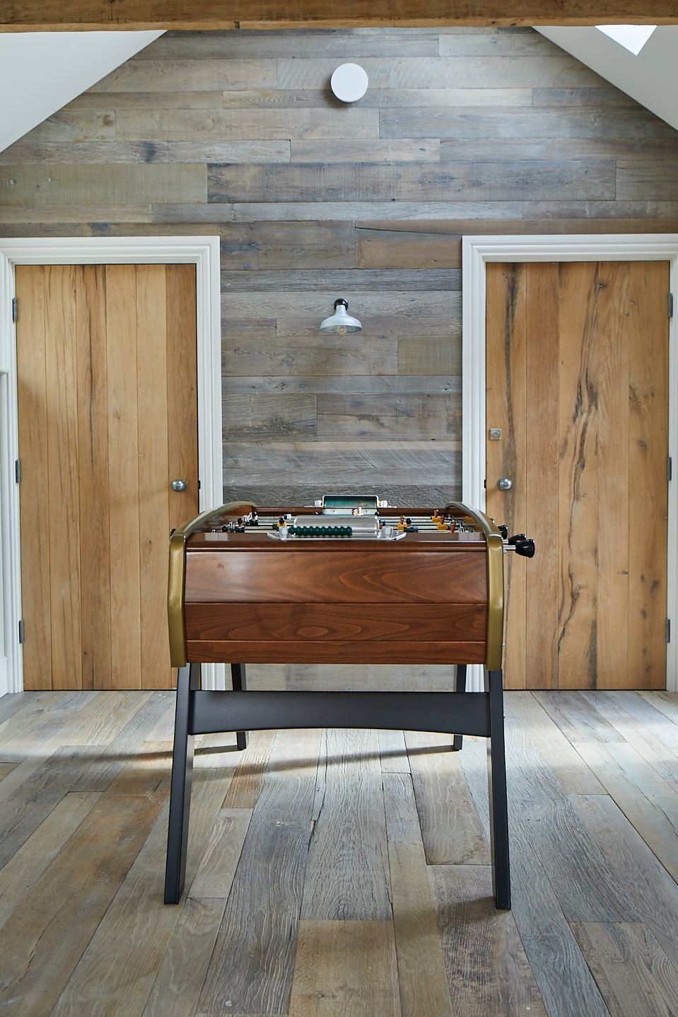 Foosball table on reclaimed oak floor