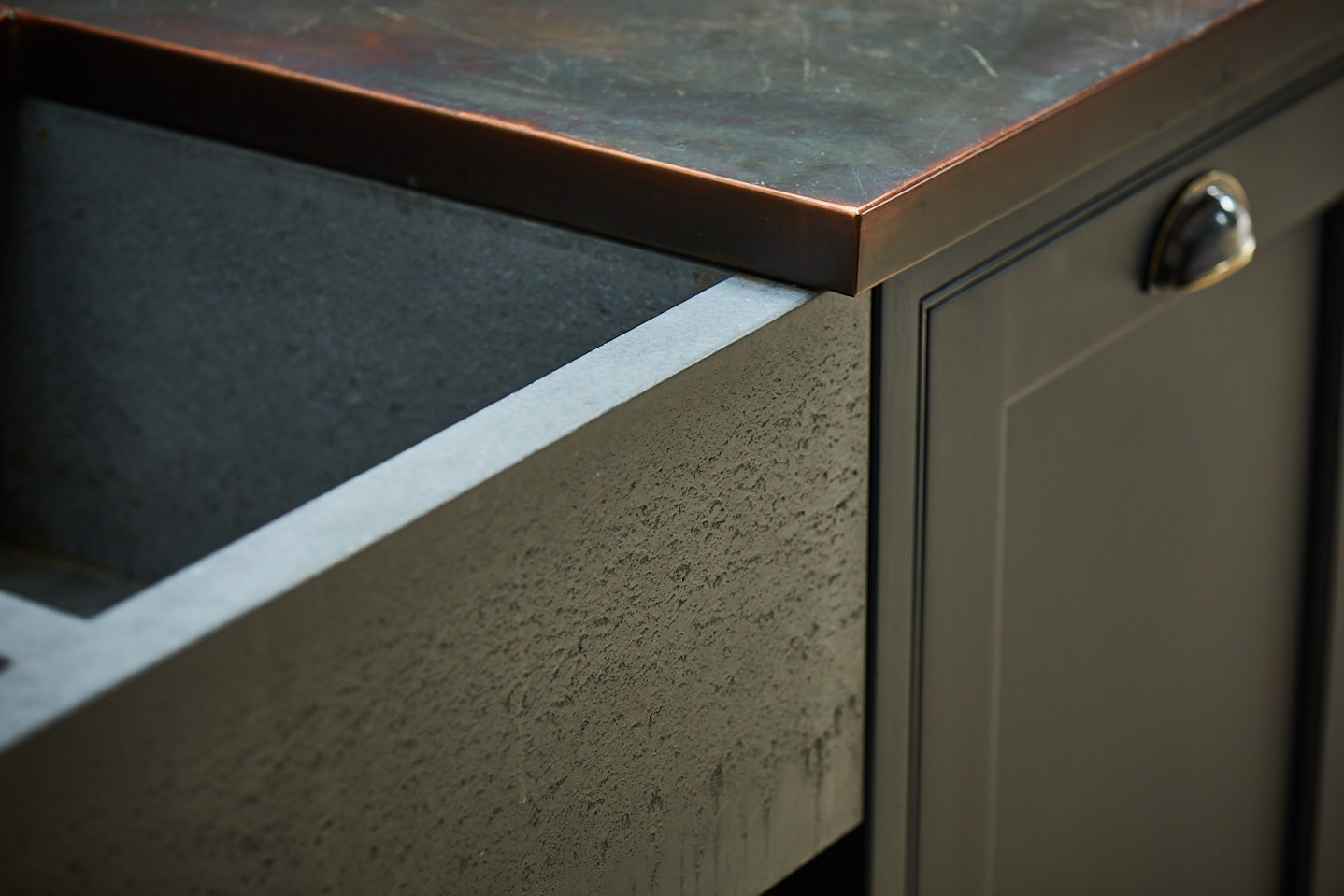 Solid concrete butler sink with aged brass worktop