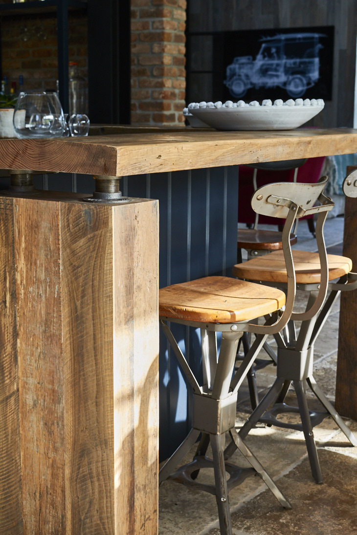 Chunky rustic breakfast bar with metal and wood barstool