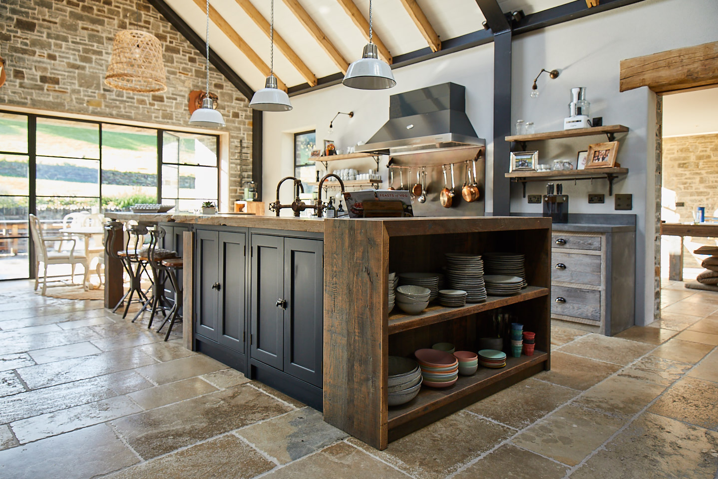 Rustic open end pot board on kitchen island displays ceramic bowls and cups