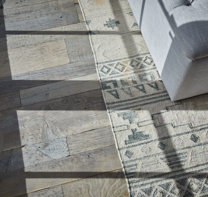 Light shines across reclaimed oak floor boards