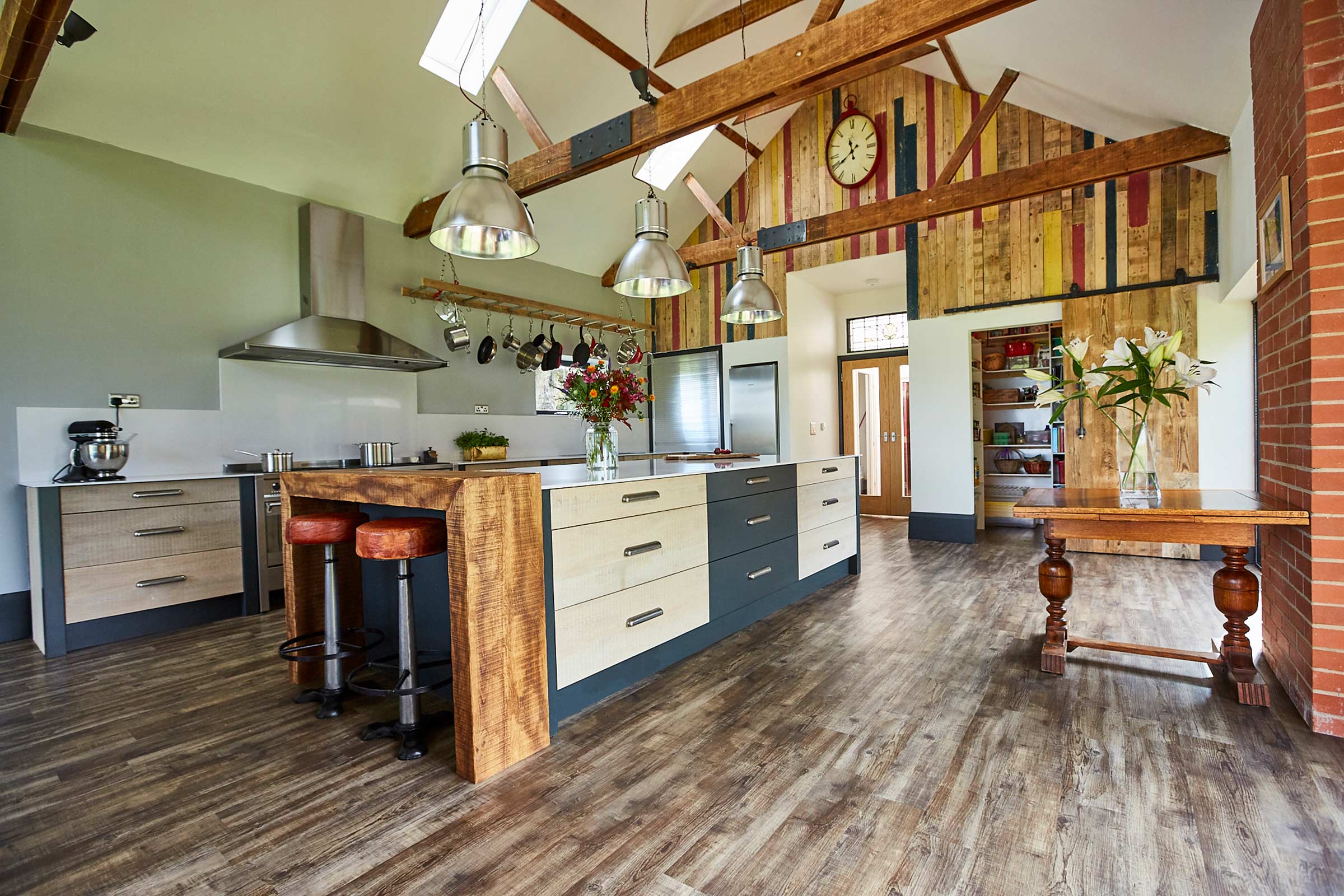 Bespoke kitchen in large vaulted ceiling room with painted and reclaimed wood drawers