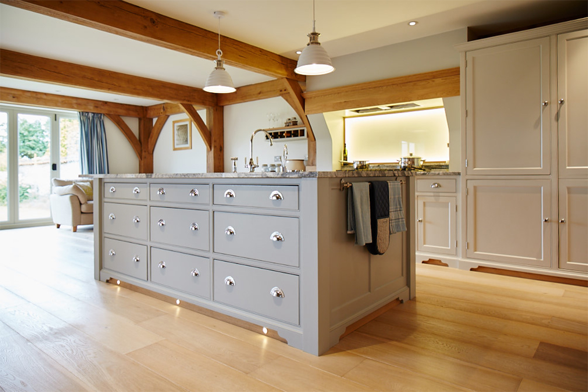 Bespoke painted kitchen island with plinth lights and chrome handles