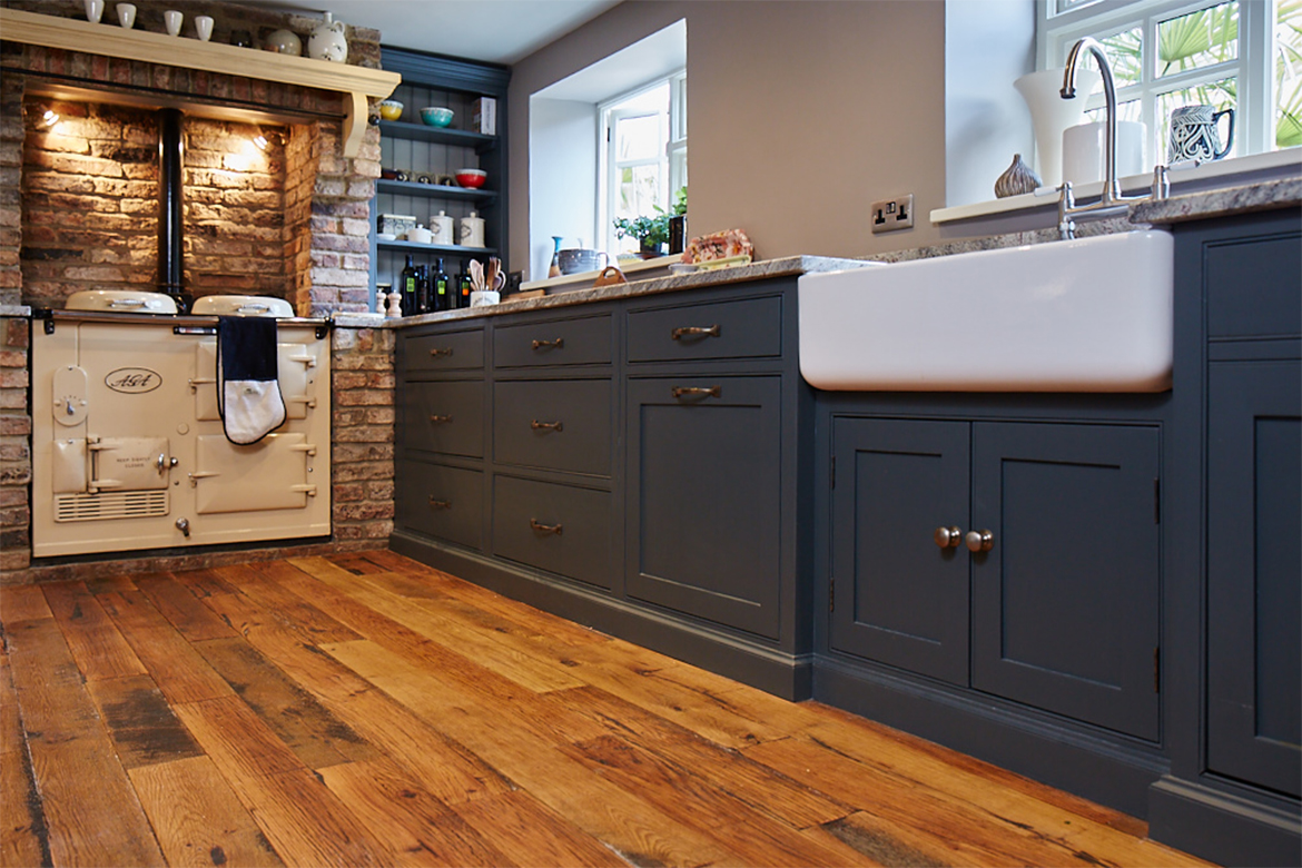 Ceramic Shaws double belfast sits on painted bespoke unit next to original cream AGA