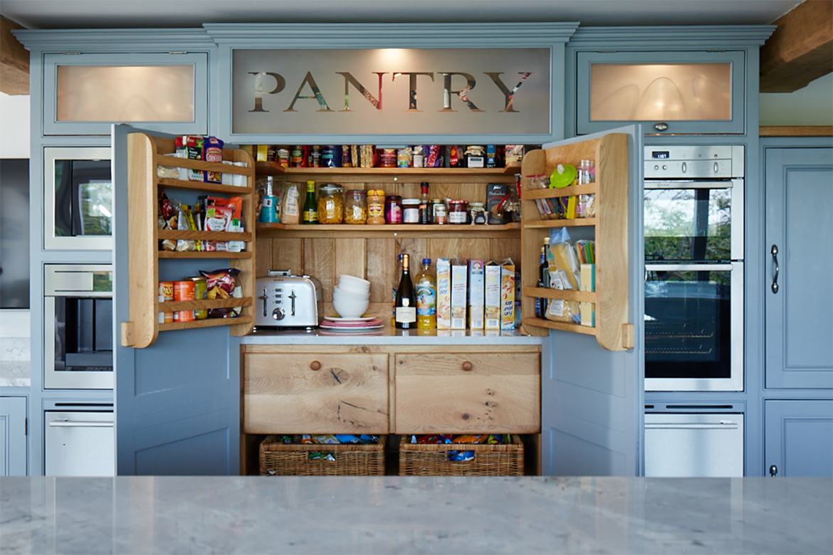 Bespoke larder with solid oak internals and internal lighting full with dry food