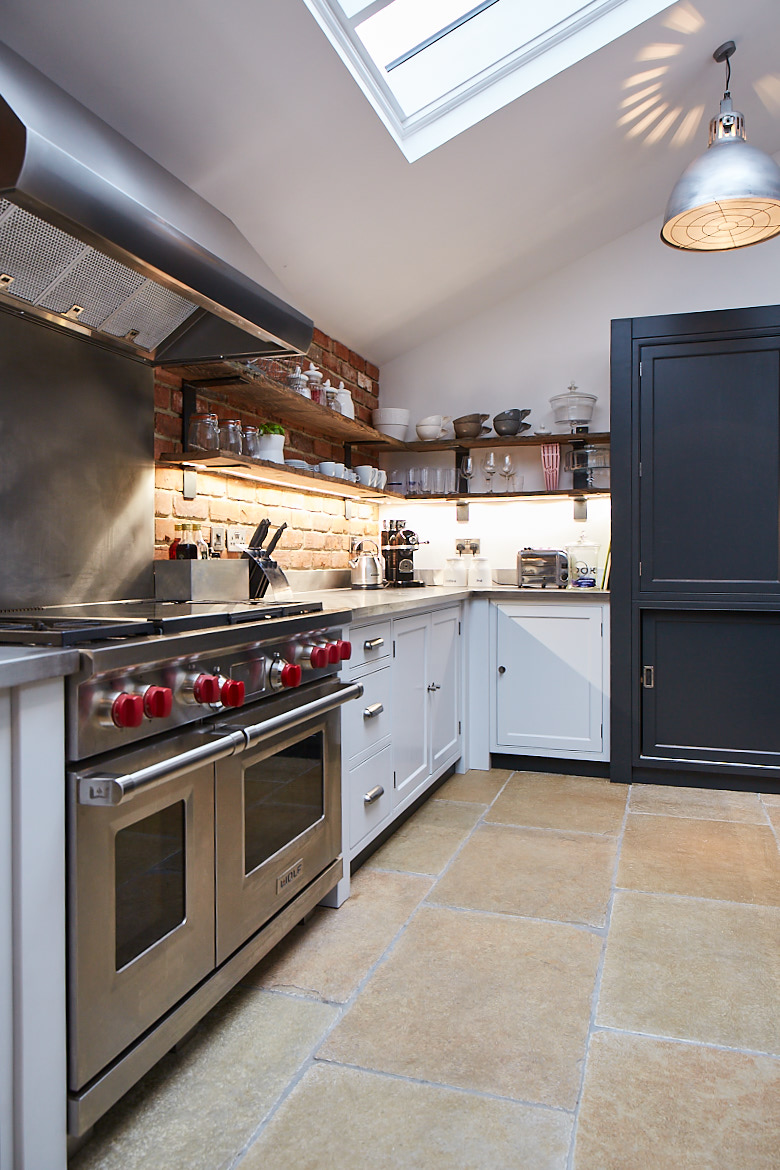 Stainless steel Wolf range cooker with painted bespoke kitchen cabinets by The Main Company