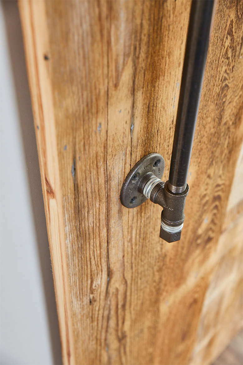 Cast iron pipes make handle on reclaimed sliding wood door