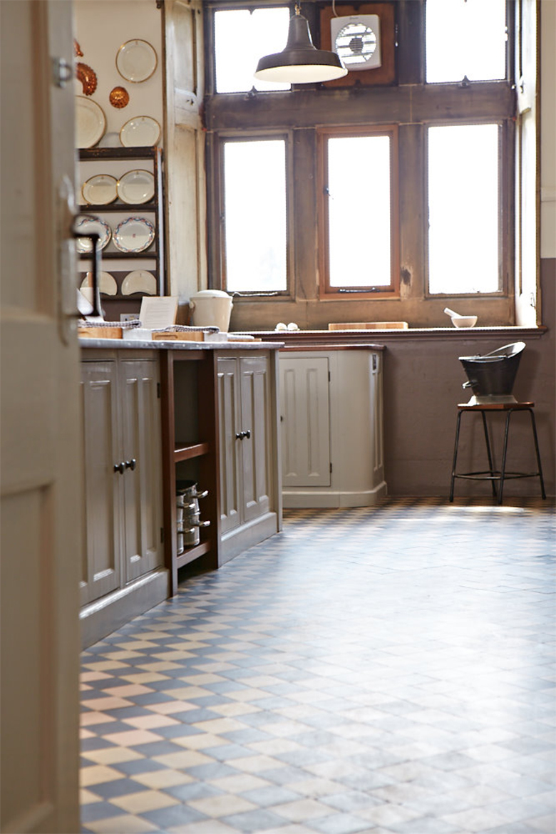 Tiled floor reflects reclaimed teak worktop and bespoke kitchen units